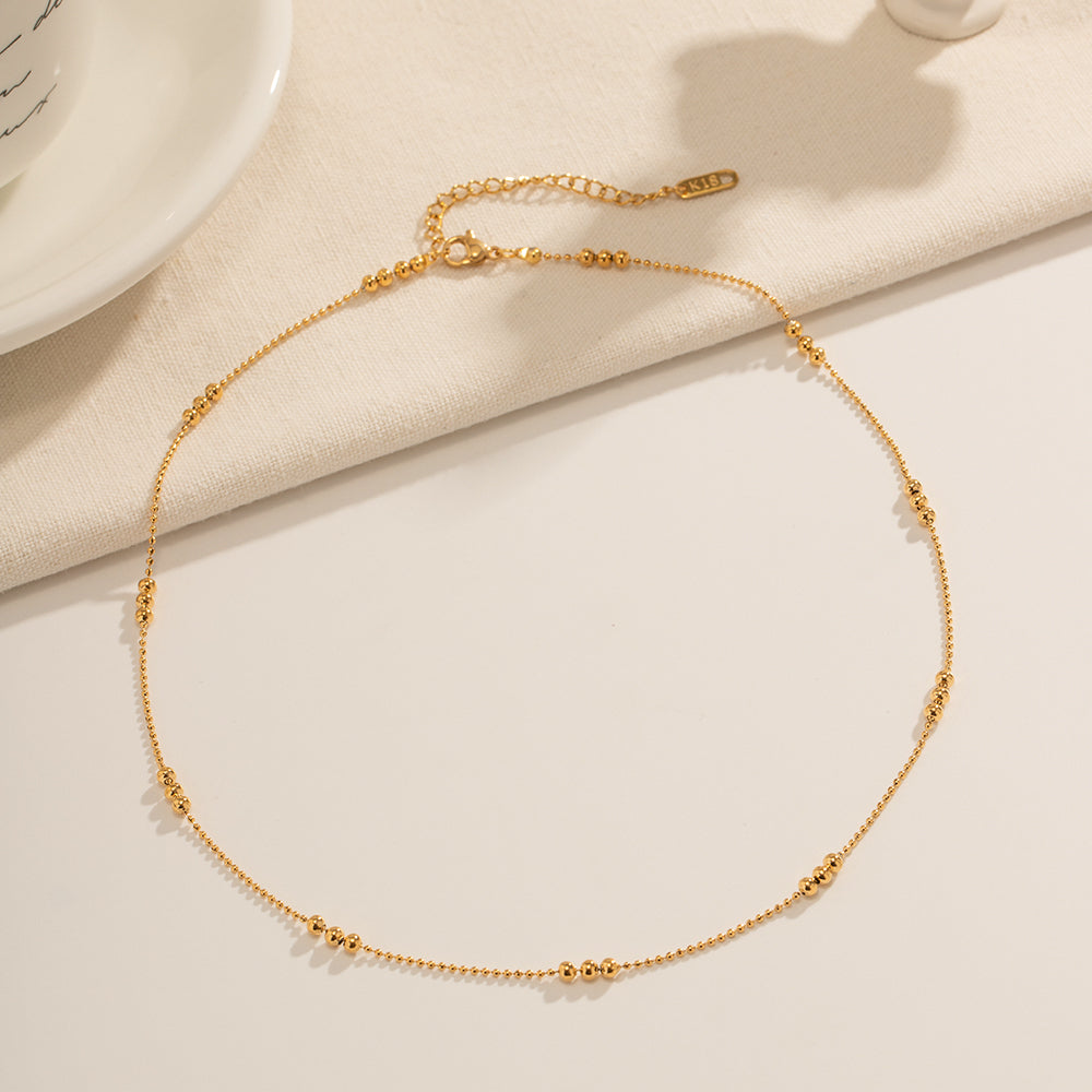 A full view of the minimalist gold necklace showing the lobster clasp and adjustable 5cm extender.