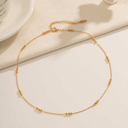A full view of the minimalist gold necklace showing the lobster clasp and adjustable 5cm extender.
