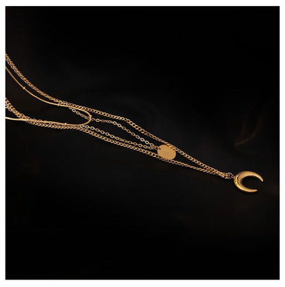 Aesthetic shot of gold-plated layered chains on a black silk surface highlighting the tarnish-free finish.