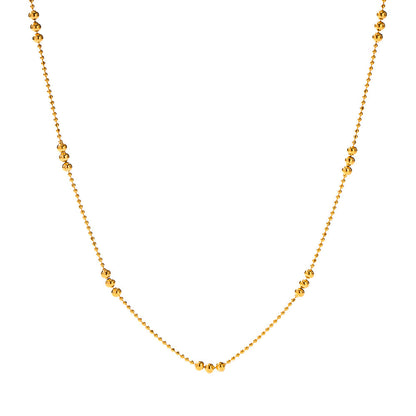 Clean studio shot of the gold ball chain necklace vertically displayed against a white background.