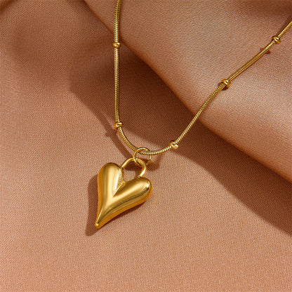 Detailed view of the high-polish gold heart pendant showing the secure attachment to the non-tarnish chain.