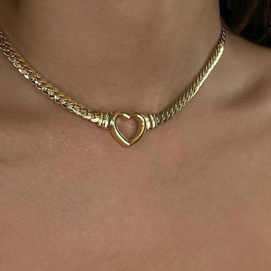 Lifestyle image of a woman wearing the bold 6mm gold heart link necklace, highlighting its retro "Fashion" fit.